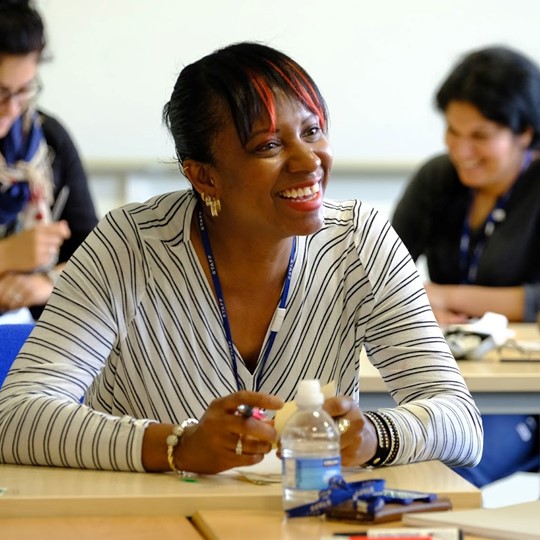 Female Teacher Smiling During A Training Course